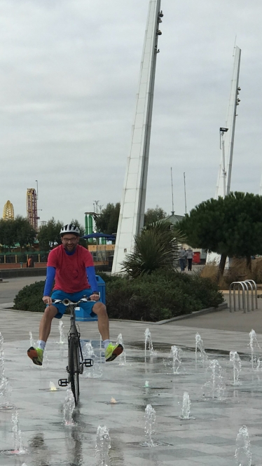 James riding his bike through the seafront fountains